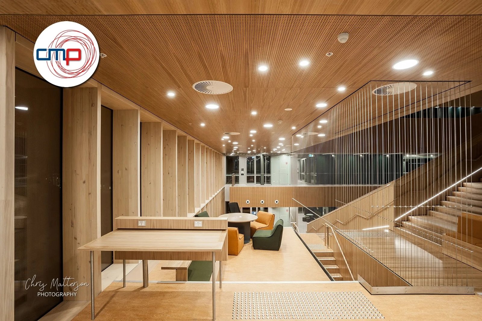 Photograph of a modern office interior with wood panelling and staircase.